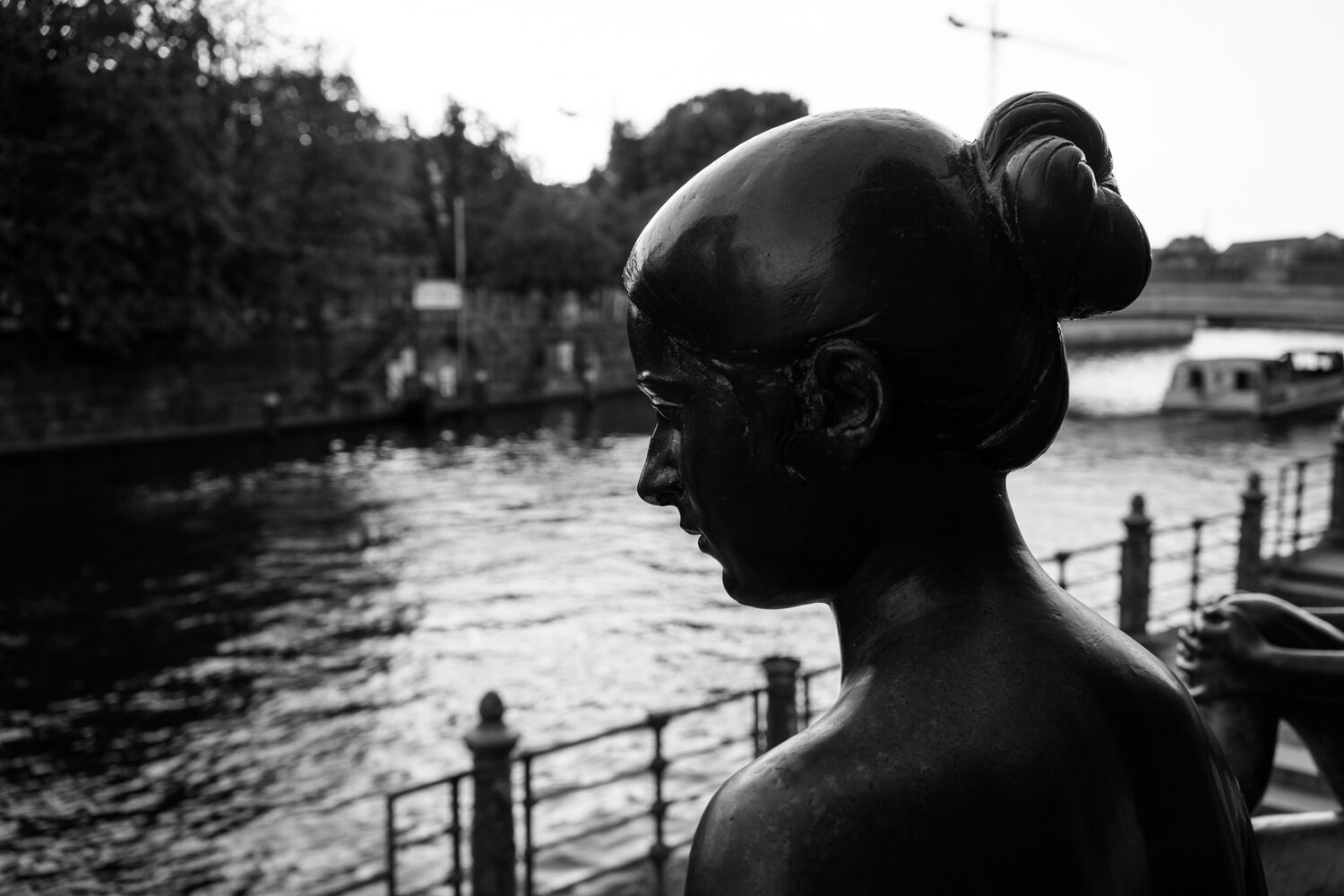 spree river berlin - statue of woman by waterfront